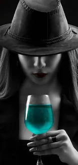 Mysterious woman in dark attire holding turquoise drink.