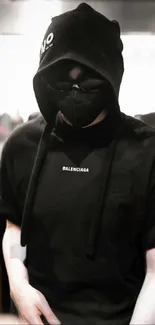 Mysterious figure in black hoodie and mask, stylish.