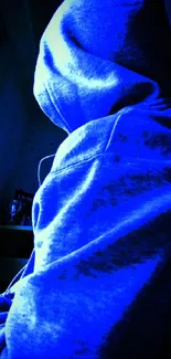 Blue hoodie figure sitting by window in a shadowy room.