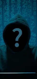 Mysterious hooded figure with laptop against code background.