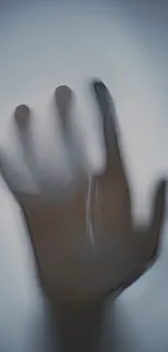 A mysterious hand silhouette against a dark background.