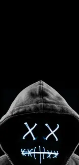 Hooded figure with glowing face on dark background wallpaper.