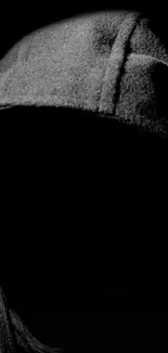 Shadowed figure in hooded silhouette artwork for mobile wallpaper.