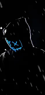 Silhouette with neon mask in dark setting, creating mysterious vibe.