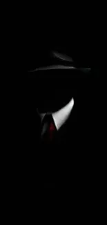 Mysterious silhouette of a suited figure in darkness.