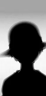 Silhouette of a mysterious figure with a hat in black and white.