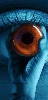 Mystical blue eye held in hand wallpaper.