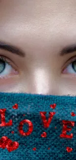 Mysterious eyes peering over a teal scarf with 'LOVE' in red letters.