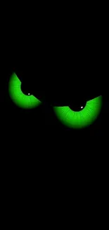 Dark wallpaper with glowing green eyes and black background.