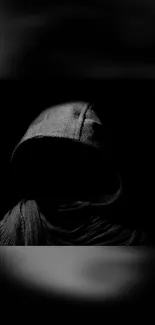 Mysterious hooded silhouette in dark wallpaper.