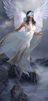 Mystical angel with wings on a cloudy sky background and rocky landscape.