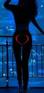 Silhouette in front of a mystical blue aquarium background with a heart detail.