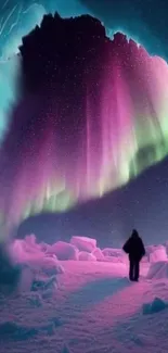 Silhouette under glowing aurora borealis in a winter landscape.