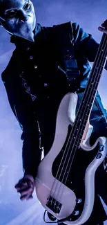 Bass guitarist in dark outfit with blue lighting on stage.