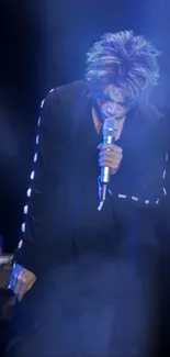 Enigmatic singer in blue hues on stage, mobile wallpaper.