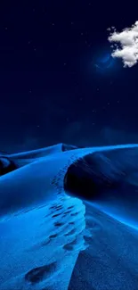 Blue desert under starry sky with footprints and colorful sand dunes.