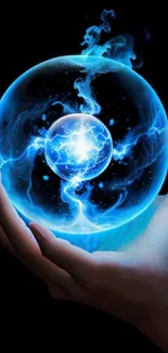 Hand holding a glowing blue energy sphere against a dark background.