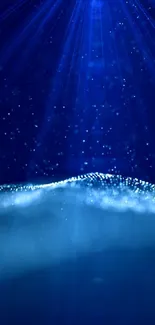 Mystical blue light wallpaper with ocean wave design and starry accents.