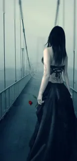 Woman in black dress on foggy bridge, holding a red rose.