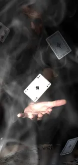 Floating playing cards in mystical smoke on dark background.