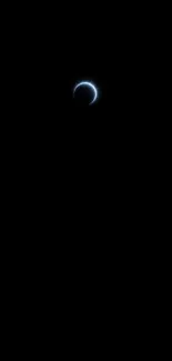 Mystical crescent eclipse in black sky.