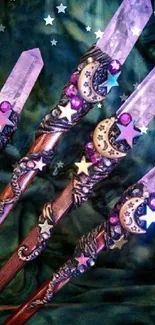 Four mystical crystal wands with starry designs on a dark green background.