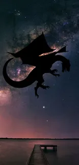 Dragon silhouette against a starry night sky above a tranquil lake.