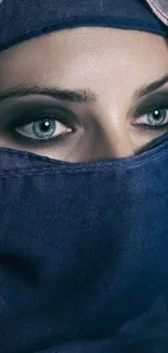 Captivating eyes veiled in deep blue fabric, exuding mystery and elegance.