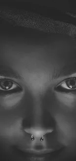 Monochrome close-up of a mysterious face with captivating eyes.