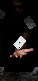 Artistic wallpaper with floating playing cards in a mystical black setting.