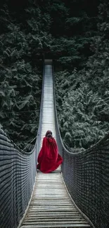 Suspension bridge through dense green forest with figure in red cloak.