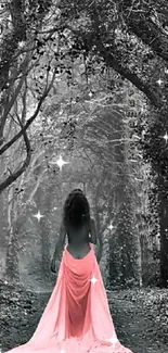 Woman in pink gown walking through a mystical forest pathway.