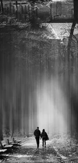 Black and white forest path with fog and trees, creating a mystical atmosphere.