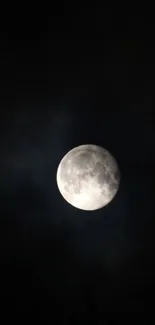 Full moon glowing in a dark night sky with a mystical aura.