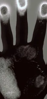 Mystical glowing hand on dark background.