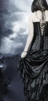 Gothic woman in a stormy night landscape with dark clouds.