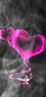 Pink heart smoke from a mystical lamp on dark background.