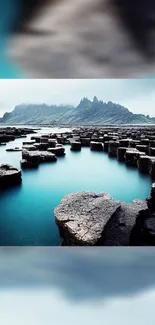 Hexagon rock formation with turquoise sea and misty hills.