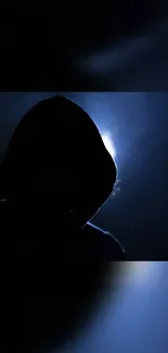 Hooded silhouette with a glowing background, creating a mysterious ambiance.