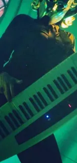 Masked musician playing keyboard with green lighting, artistic wallpaper.