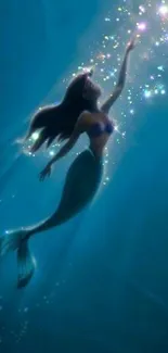 Mermaid swimming in a mystical ocean with shimmering lights.