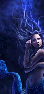 Mystical mermaid surrounded by deep blue hues in a fantasy art wallpaper.