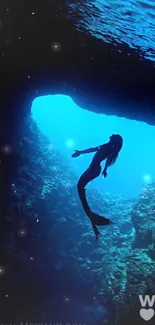 Silhouette of mermaid swimming in a blue underwater sea cave scene.