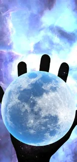 Hand holding a glowing moon with cosmic background in blue hues.