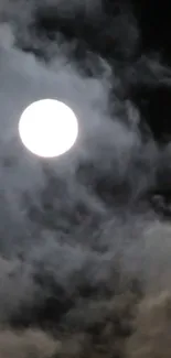 Full moon behind dark, cloudy night sky.