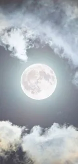 Full moon surrounded by clouds in a serene night sky.