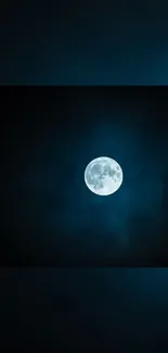 Glowing full moon against a deep blue night sky.