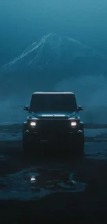 A solitary car driving on a foggy road with a mountain in the backdrop.