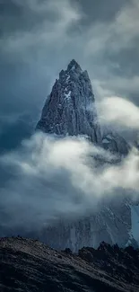 Misty mountain peak with clouds in a dramatic landscape.