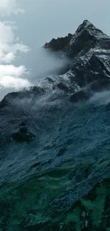 Foggy mountain peaks with lush green slopes.